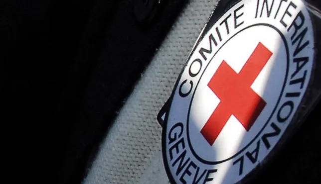 An image shows the emblem of the International Committee of the Red Cross